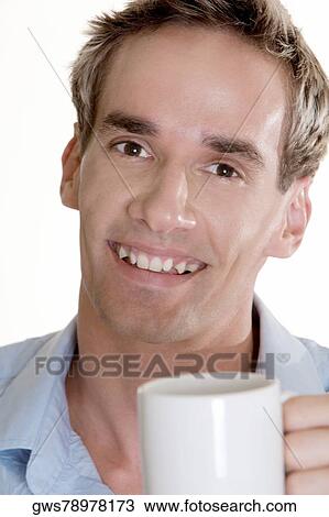 Stock Image - Portrait of a mid adult man holding a cup. Fotosearch