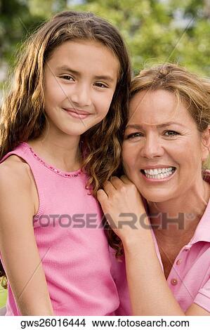 Portrait of a mother and her daughter smiling View Large Photo Image Picture - Portrait of a mother and her daughter smiling. Fotosearch