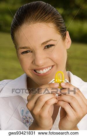 Portrait of a teenage girl holding a condom View Large Photo Image Stock Image - Portrait of a teenage girl holding a condom. Fotosearch