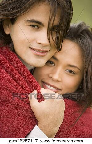 Stock Photo - Portrait of a young couple embracing each other. Fotosearch
