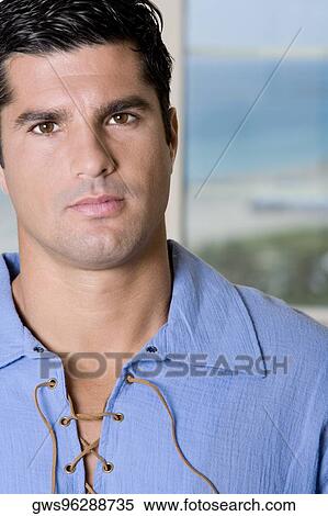Portrait of a young man looking serious View Large Photo Image Stock Photography - Portrait of a young man looking serious. Fotosearch
