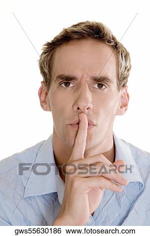 Portrait of a young man with a finger on his lip View Large Photo Image Stock Photograph - Portrait of a young man with a finger on his lip. Fotosearch