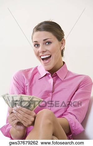 Portrait of a young woman counting American currency View Large Photo Image Stock Image - Portrait of a young woman counting American currency. Fotosearch