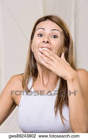 Stock Image - Portrait of a young woman laughing. Fotosearch