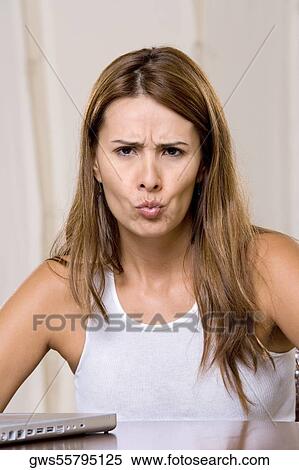 Portrait of a young woman puckering her lips View Large Photo Image Stock Photography - Portrait of a young woman puckering her lips. Fotosearch