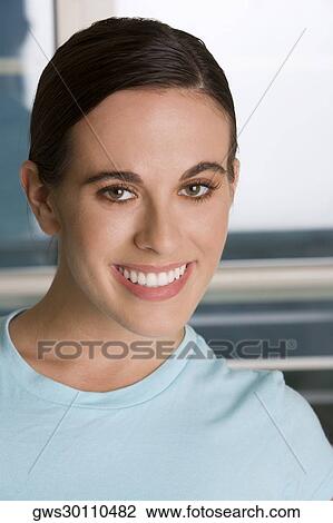 Portrait of a young woman smiling View Large Photo Image Stock Image - Portrait of a young woman smiling. Fotosearch