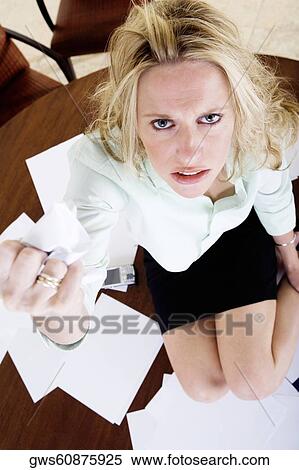 Portrait of a young woman squashing a sheet of paper View Large Photo Image Stock Photography - Portrait of a young woman squashing a sheet of paper. Fotosearch