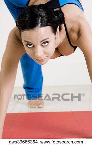 Portrait of a young woman standing on one leg View Large Photo Image Picture - Portrait of a young woman standing on one leg. Fotosearch