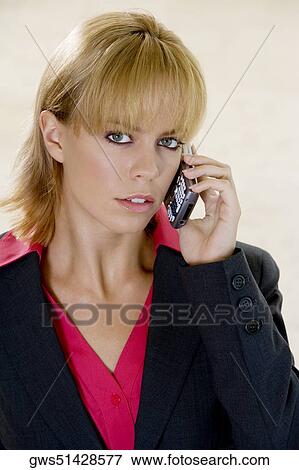 Portrait of a young woman talking on a mobile phone View Large Photo Image Stock Photo - Portrait of a young woman talking on a mobile phone. Fotosearch