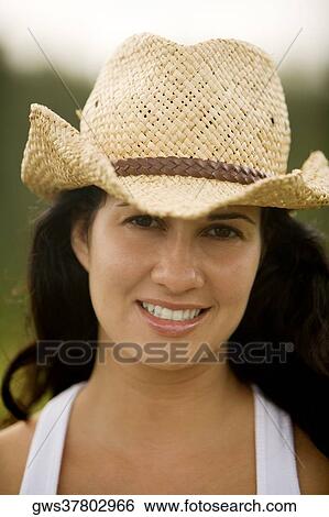 Portrait of a young woman wearing a cowboy hat View Large Photo Image Stock Photograph - Portrait of a young woman wearing a cowboy hat. Fotosearch