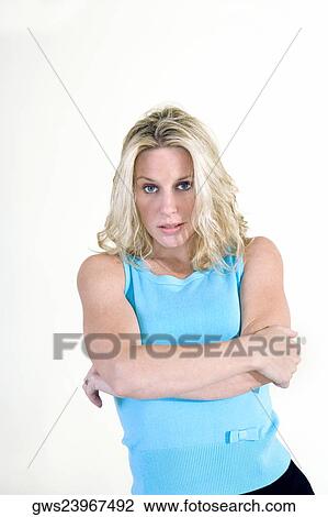Stock Image - Portrait of a young woman with her arms crossed. Fotosearch