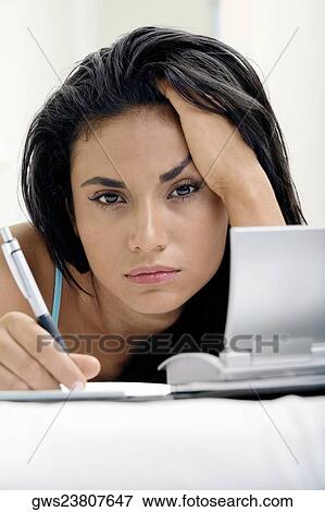 Portrait of a young woman with her hand on her head View Large Photo Image Stock Photo - Portrait of a young woman with her hand on her head. Fotosearch