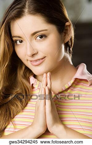 Portrait of a young woman with her hands together View Large Photo Image Stock Photography - Portrait of a young woman with her hands together. Fotosearch