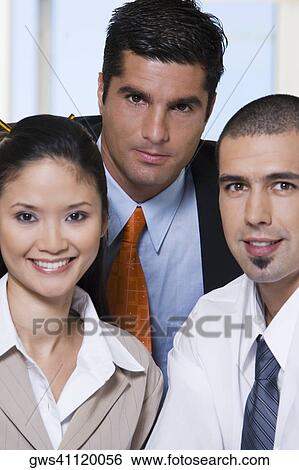 Portrait of two businessmen and a businesswoman in an office View Large Photo Image Stock Photograph - Portrait of two businessmen and a businesswoman in an office. Fotosearch