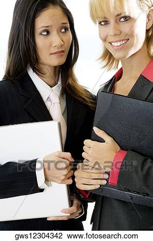 Portrait of two businesswomen smiling View Large Photo Image Stock Image - Portrait of two businesswomen smiling. Fotosearch