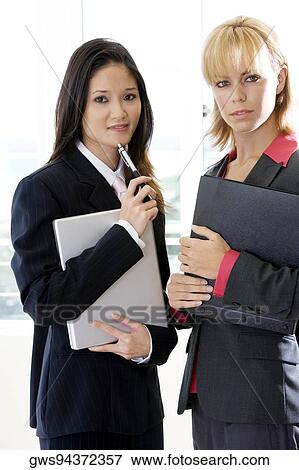 Portrait of two businesswomen standing together View Large Photo Image Stock Photo - Portrait of two businesswomen standing together. Fotosearch