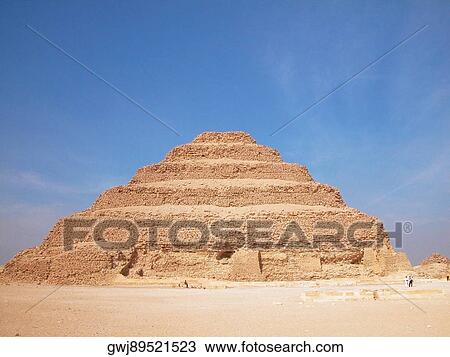Stock Image - Pyramid in an arid landscape, The Step Pyramid Of Zoser, Saqqara, Egypt. Fotosearch