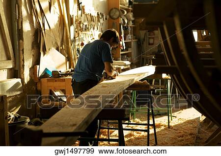 Rear view of a carpenter working in a workshop, Spain View Large Photo Image Stock Photo - Rear view of a carpenter working in a workshop, Spain. Fotosearch