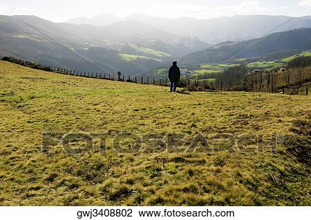 Rear view of a man standing on a hillside, Spain View Large Photo Image Stock Image - Rear view of a man standing on a hillside, Spain. Fotosearch