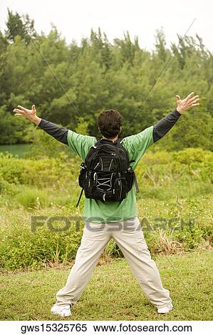 Rear view of a mid adult man carrying a backpack View Large Photo Image Stock Photography - Rear view of a mid adult man carrying a backpack. Fotosearch