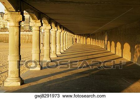 Rear view of a person walking in a pillared corridor, Spain View Large Photo Image Stock Image - Rear view of a person walking in a pillared corridor, Spain. Fotosearch