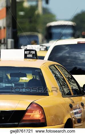 Stock Image - Rear view of traffic in a city. Fotosearch