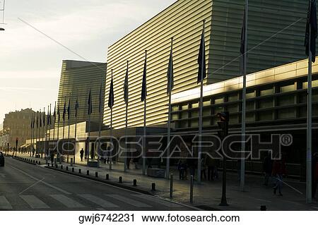 Row of flag poles in front of a building, Spain View Large Photo Image Stock Image - Row of flag poles in front of a building, Spain. Fotosearch