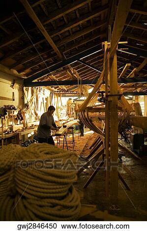 Stock Image - Side profile of a carpenter working in a workshop, Spain. Fotosearch