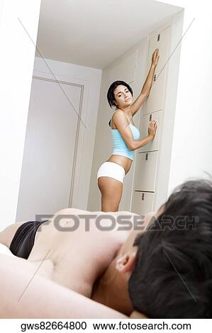 Side profile of a young woman looking at a young man View Large Photo Image Stock Image - Side profile of a young woman looking at a young man. Fotosearch