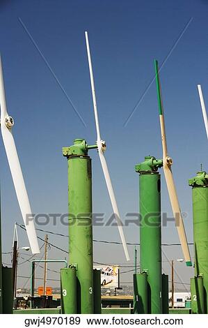 Side profile of an array of windmills on a farm View Large Photo Image Stock Photo - Side profile of an array of windmills on a farm. Fotosearch