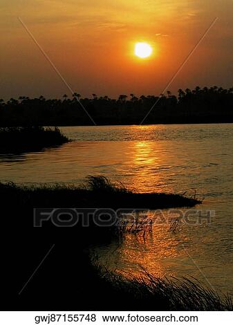 Sunset over a river View Large Photo Image Stock Photo - Sunset over a river. Fotosearch