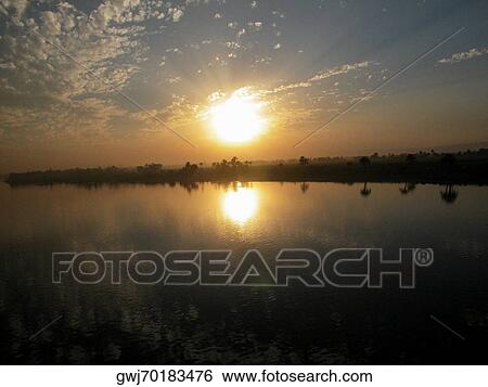 Sunset over a river View Large Photo Image Stock Photograph - Sunset over a river. Fotosearch
