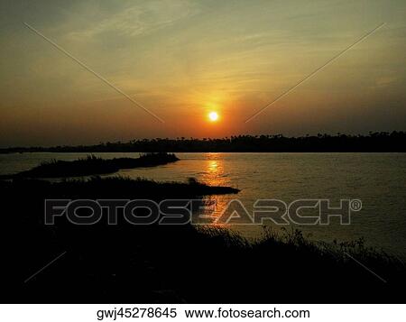 Sunset over a river View Large Photo Image Stock Photography - Sunset over a river. Fotosearch