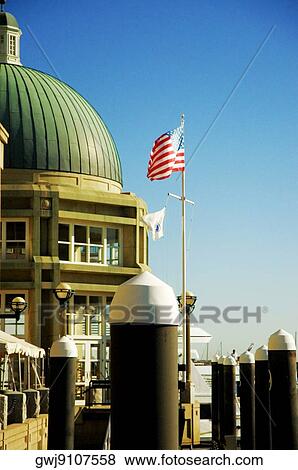American Flag in front of a building, Rowes Wharf, Boston Harbor, Boston, Massachusetts, USA View Large Photo Image Stock Photo - American Flag in front of a building, Rowes Wharf, Boston Harbor, Boston, Massachusetts, USA. Fotosearch