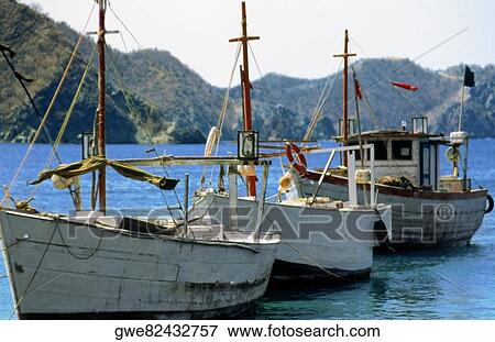 Boats moored in the sea View Large Photo Image Stock Photo - Boats moored in the sea. Fotosearch