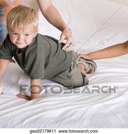 Boy crawling on a bed View Large Photo Image Stock Image - Boy crawling on a bed. Fotosearch