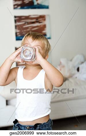 Boy drinking from a water bottle View Large Photo Image Stock Photo - Boy drinking from a water bottle. Fotosearch
