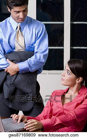 Businessman and a businesswoman looking at each other View Large Photo Image Stock Photo - Businessman and a businesswoman looking at each other. Fotosearch