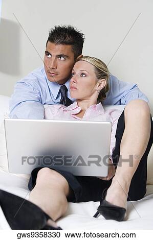 Businessman and a businesswoman using a laptop View Large Photo Image Stock Image - Businessman and a businesswoman using a laptop. Fotosearch