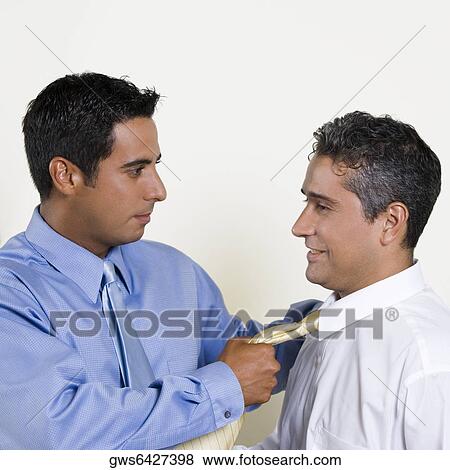 Businessman pulling his Colleague's tie View Large Photo Image Stock Photo - Businessman pulling his Colleague's tie. Fotosearch