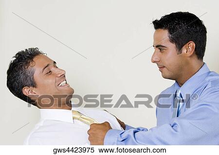 Businessman pulling his Colleague's tie View Large Photo Image Stock Photography - Businessman pulling his Colleague's tie. Fotosearch