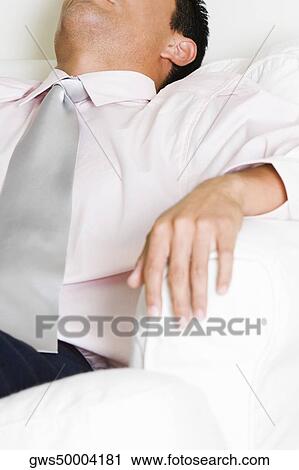 Businessman sleeping in an armchair View Large Photo Image Stock Image - Businessman sleeping in an armchair. Fotosearch