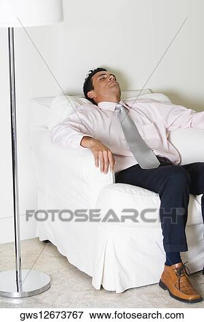 Businessman sleeping in an armchair View Large Photo Image Stock Photo - Businessman sleeping in an armchair. Fotosearch