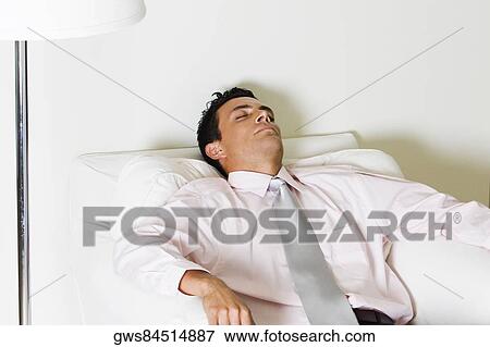 Businessman sleeping in an armchair View Large Photo Image Stock Photo - Businessman sleeping in an armchair. Fotosearch