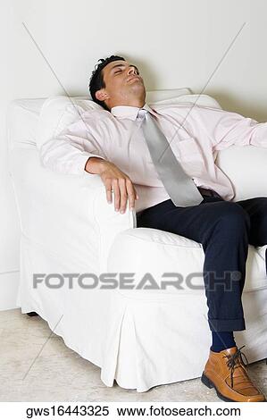 Businessman sleeping in an armchair View Large Photo Image Stock Photography - Businessman sleeping in an armchair. Fotosearch
