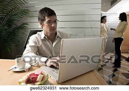 Businessman using a laptop View Large Photo Image Stock Image - Businessman using a laptop. Fotosearch