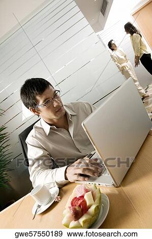 Businessman using a laptop View Large Photo Image Stock Photo - Businessman using a laptop. Fotosearch
