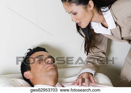 Businesswoman bending over a businessman sitting on a couch View Large Photo Image Stock Image - Businesswoman bending over a businessman sitting on a couch. Fotosearch