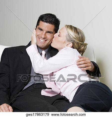 Stock Photo - Businesswoman kissing a businessman. Fotosearch