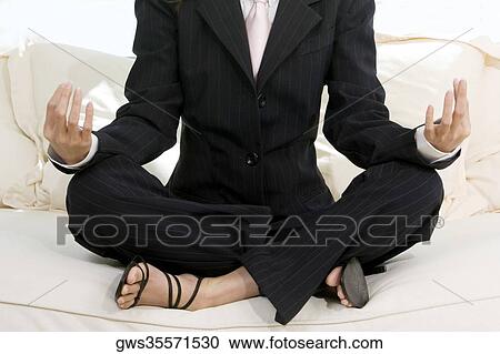 Businesswoman sitting in the lotus position View Large Photo Image Stock Image - Businesswoman sitting in the lotus position. Fotosearch